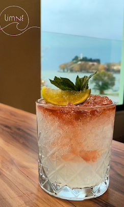 Pink cocktail with lake view
