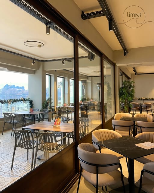 Dining area with glass walls overlooking the lake